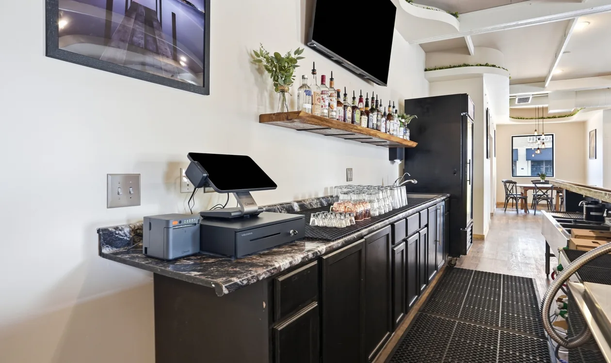 The bar service station at Venue 209 with point-of-sale terminal, glassware and speed rail