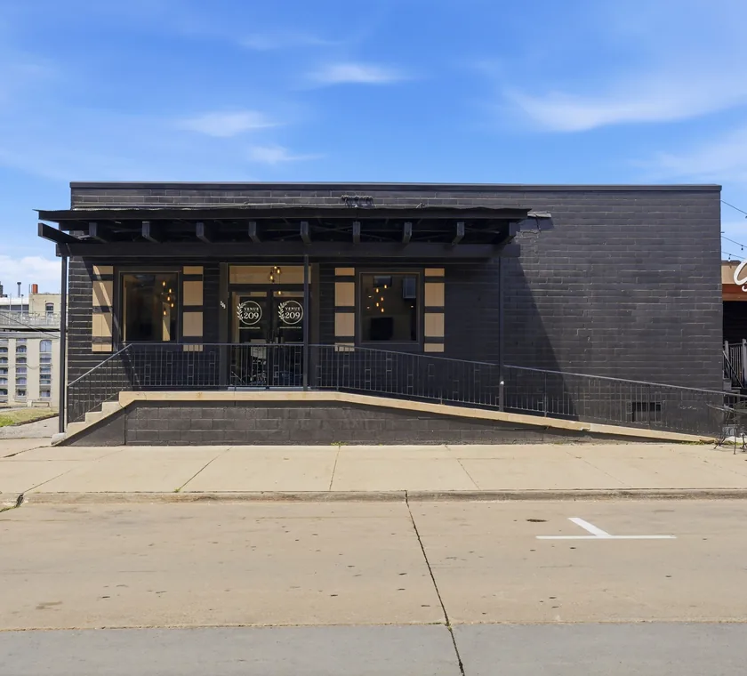The black brick exterior of Venue 209 at 209 State Street in downtown Cedar Falls, Iowa