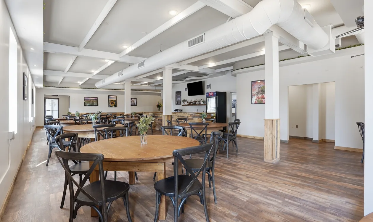 The main hall at Venue 209 looking toward the reclaimed wood bar and mounted screen