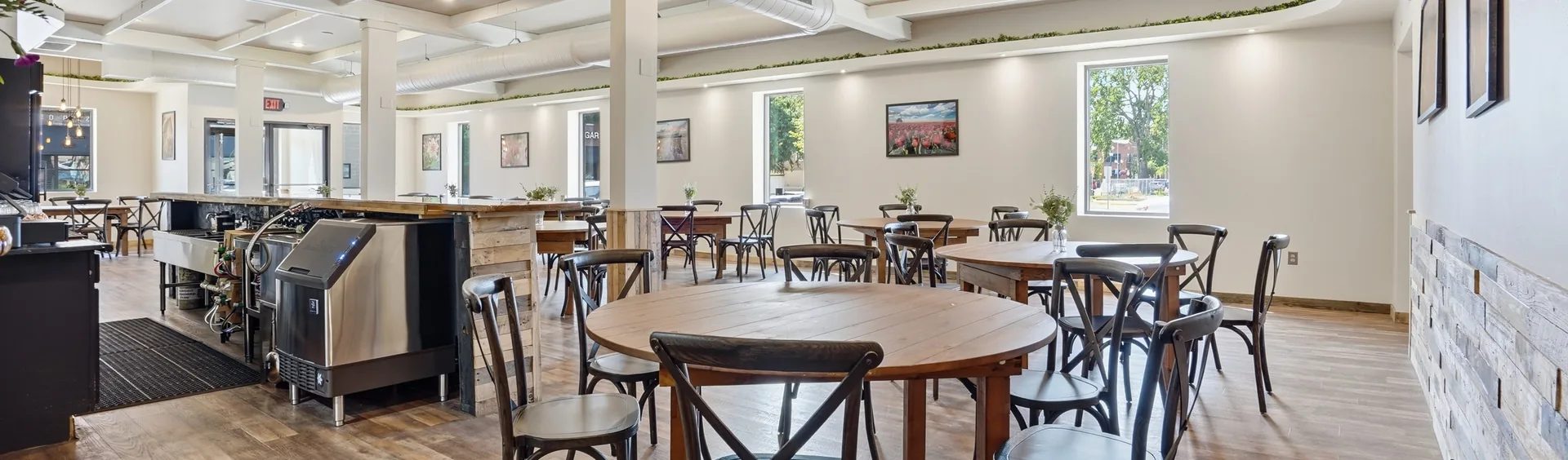 A wide panorama across the main hall at Venue 209 from behind the bar toward the front entrance