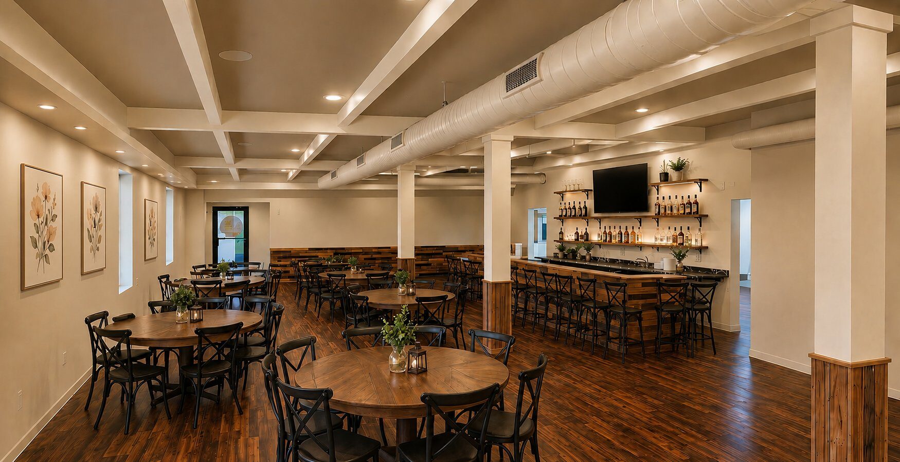 Inside Venue 209 — warm wood floors, modern farmhouse decor, round tables set for an event, with the Cypress Lounge bar in the background